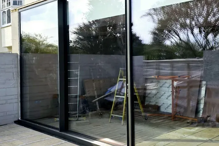 Large aluminium sliding doors with slim frames opening onto a patio