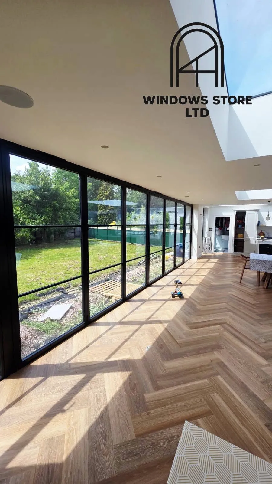 Aluminium bifold doors stacked open onto a garden, London