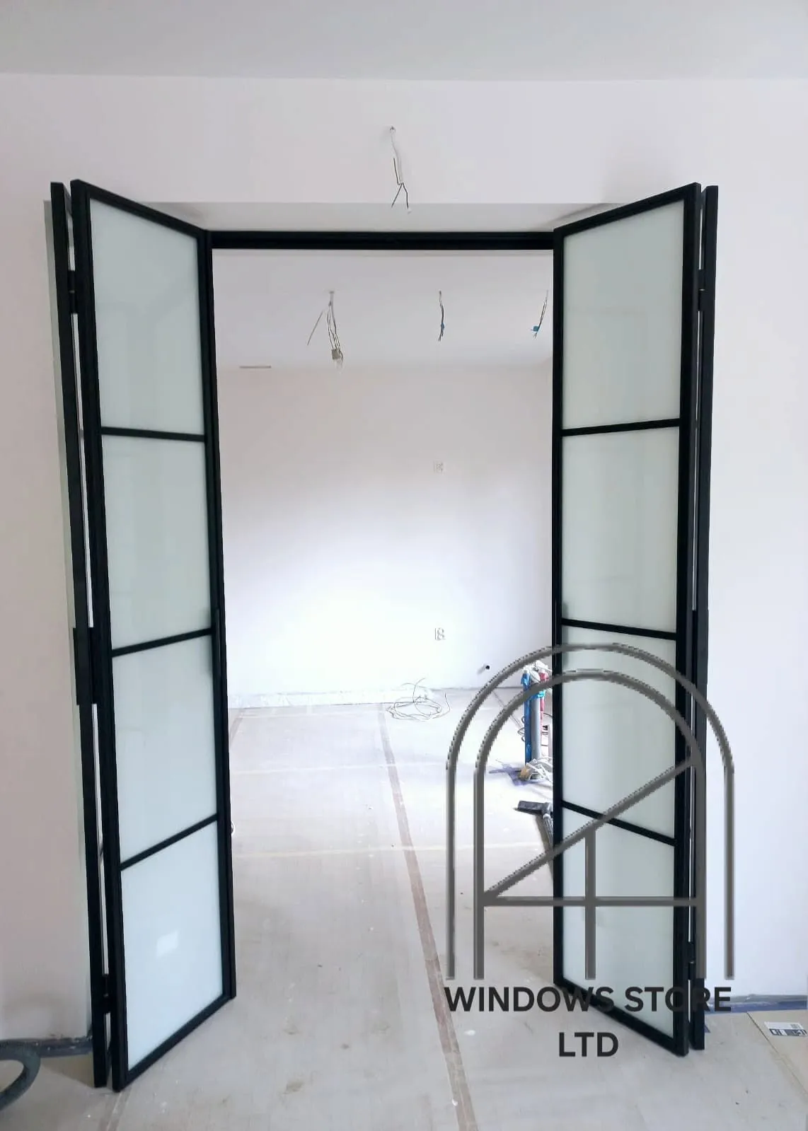 Black aluminium bifold doors closed across a rear wall, London