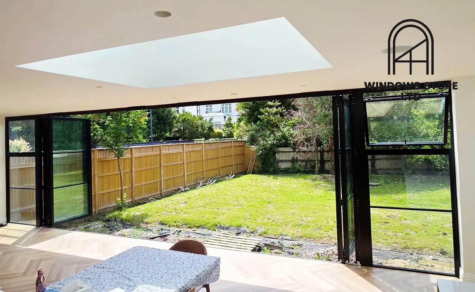 Aluminium bifold doors with large panes onto a terrace, London