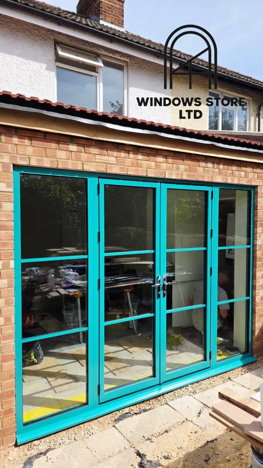 Crittall-style aluminium doors with slim black frames and grid glazing bars, London