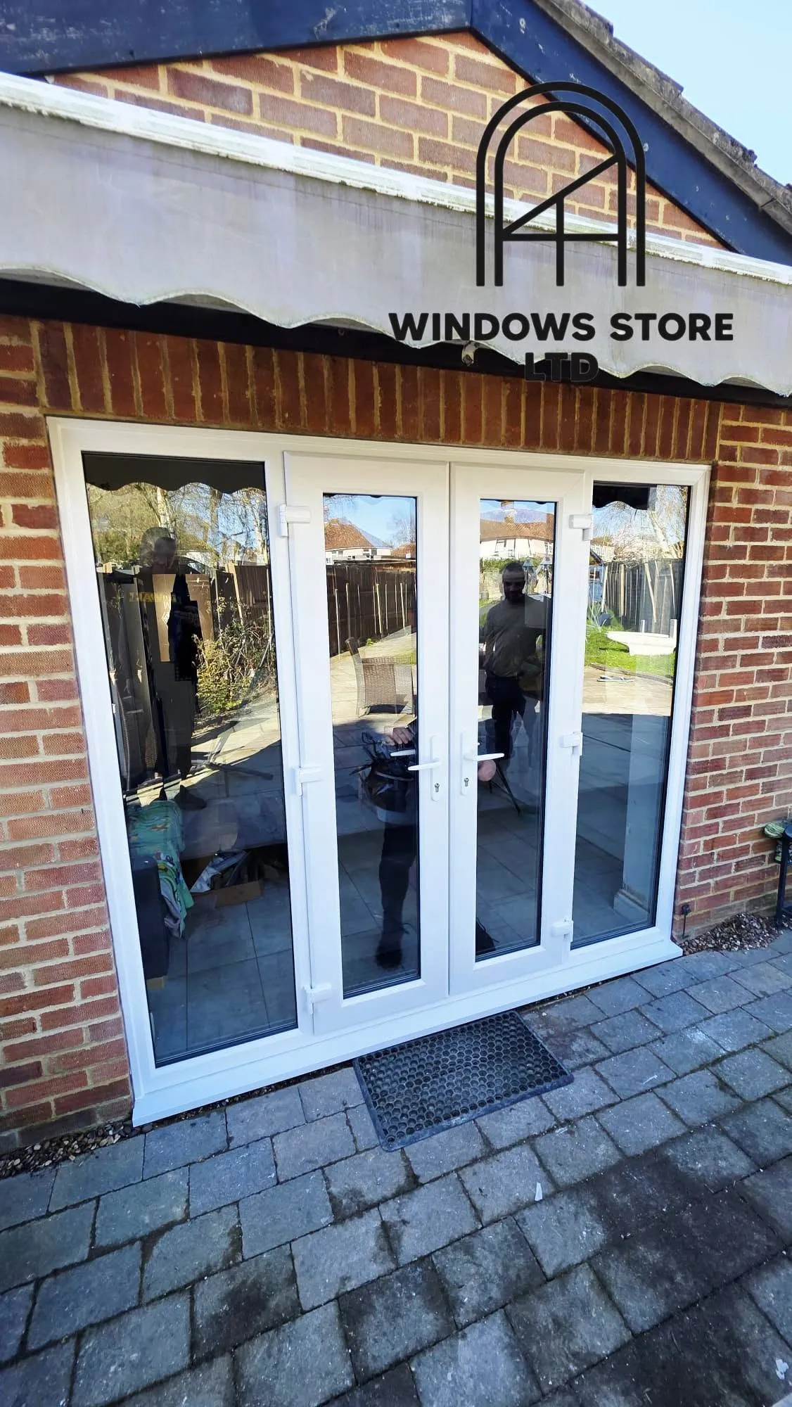 White French doors with fixed side panels onto a patio, London