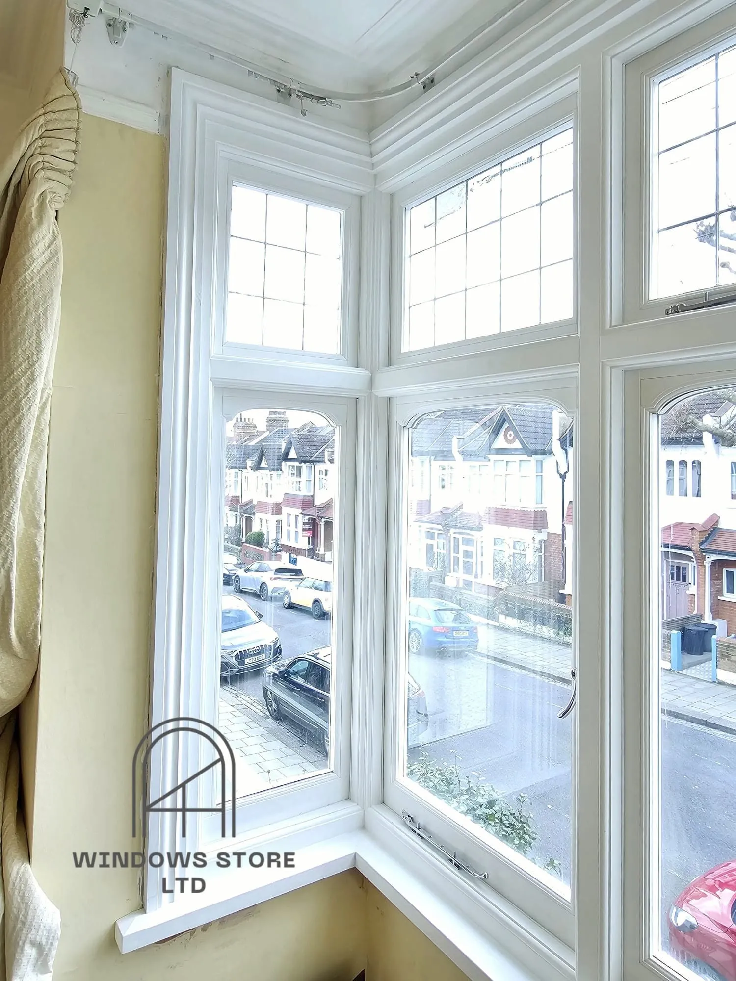 Timber casement windows in a bay with leaded top lights, London