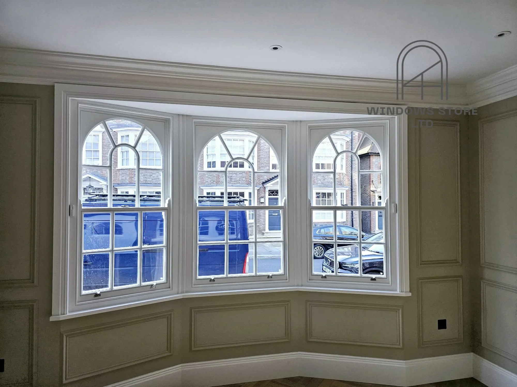 Curved bay of arched-head timber sash windows, London