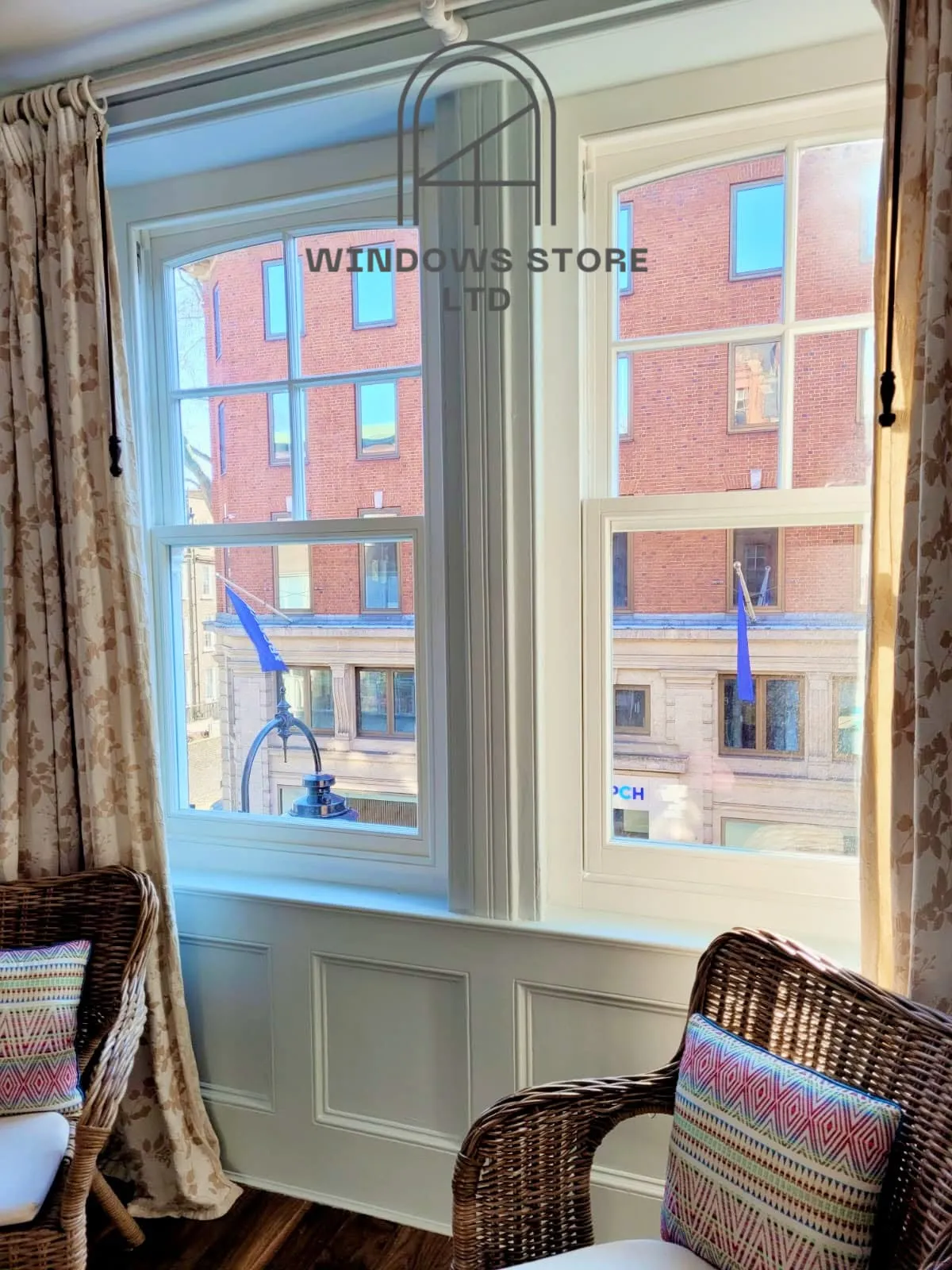 Pair of timber sliding sash windows in a panelled London room