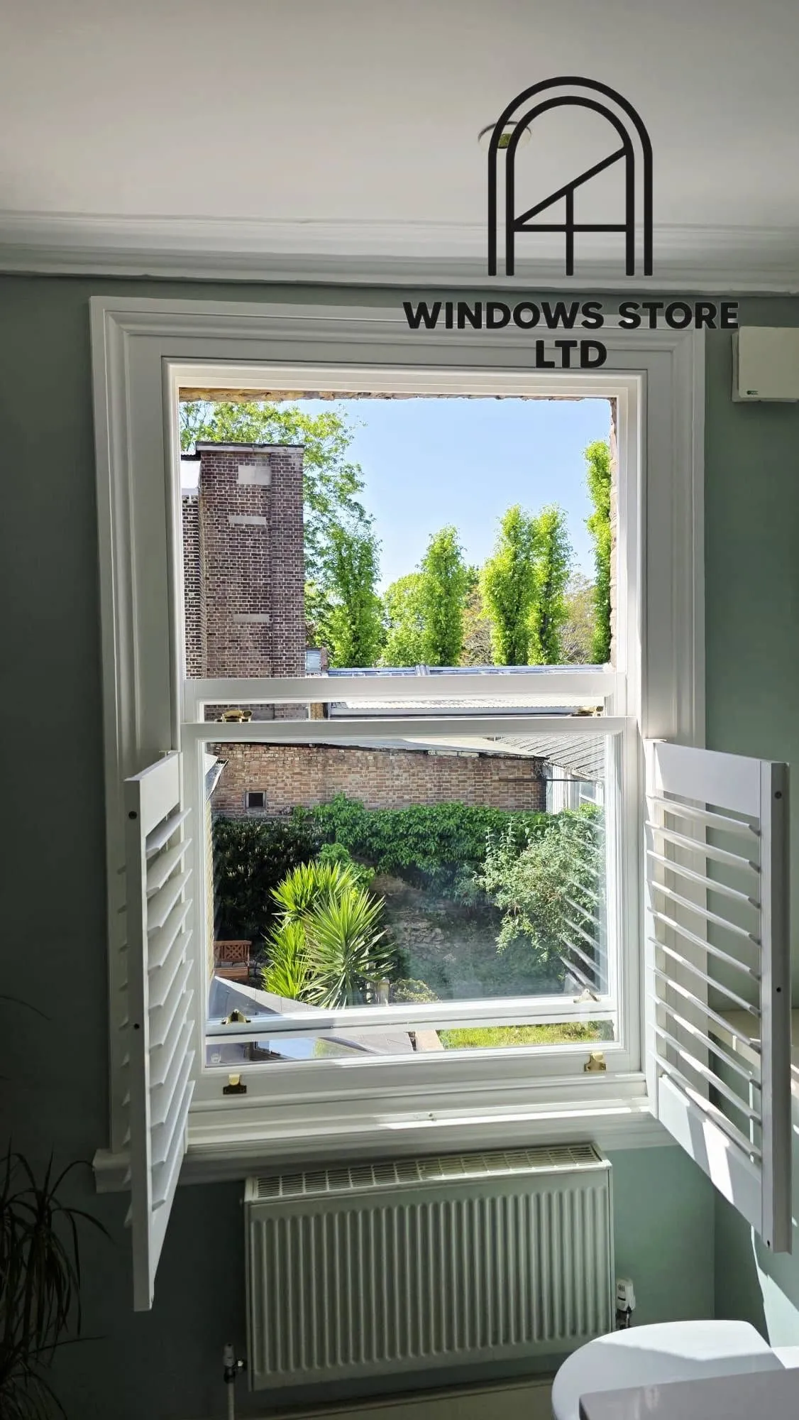 Café-style interior shutters on a sash window, London