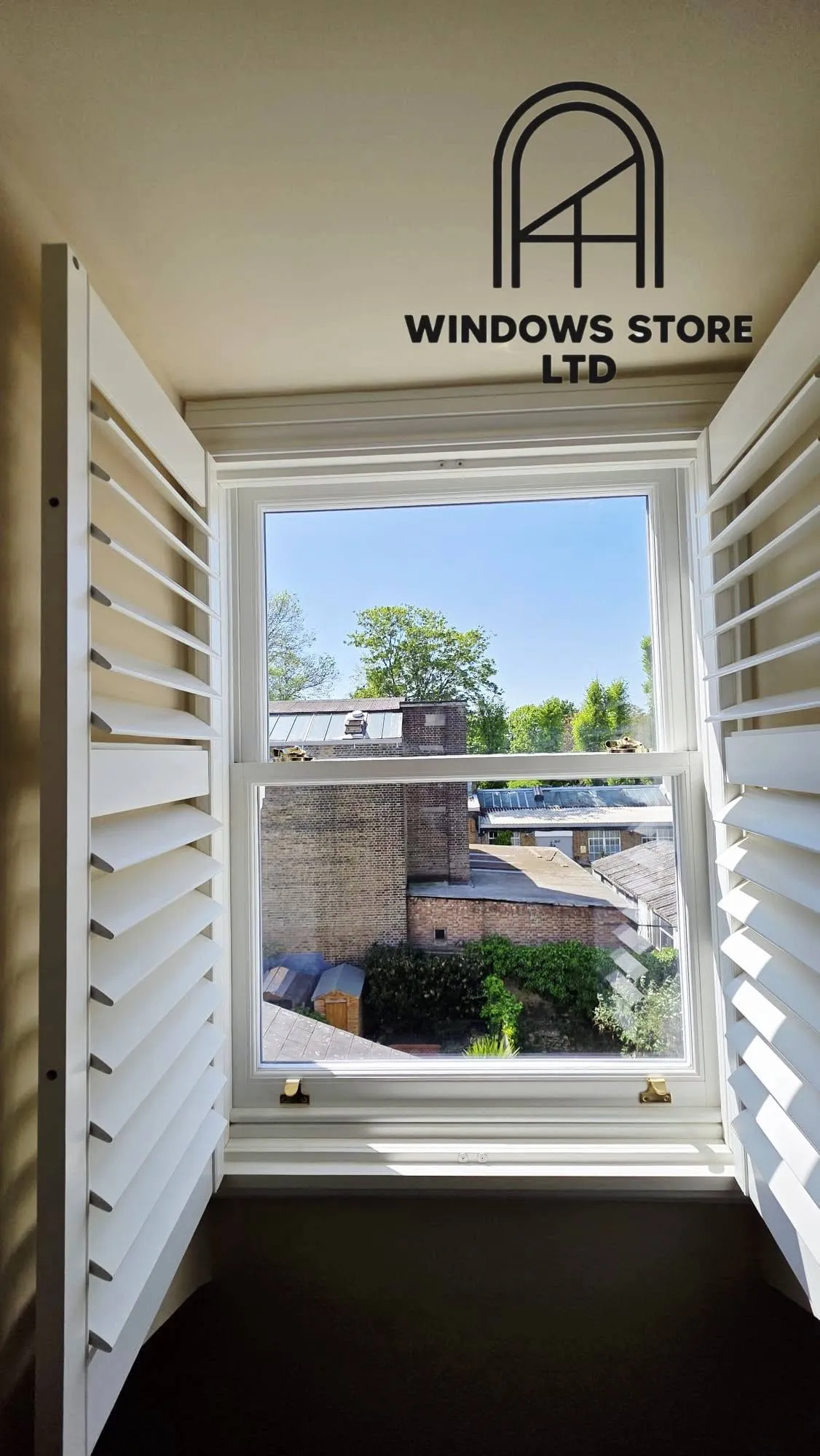 Tier-on-tier interior shutters in a bay window, London