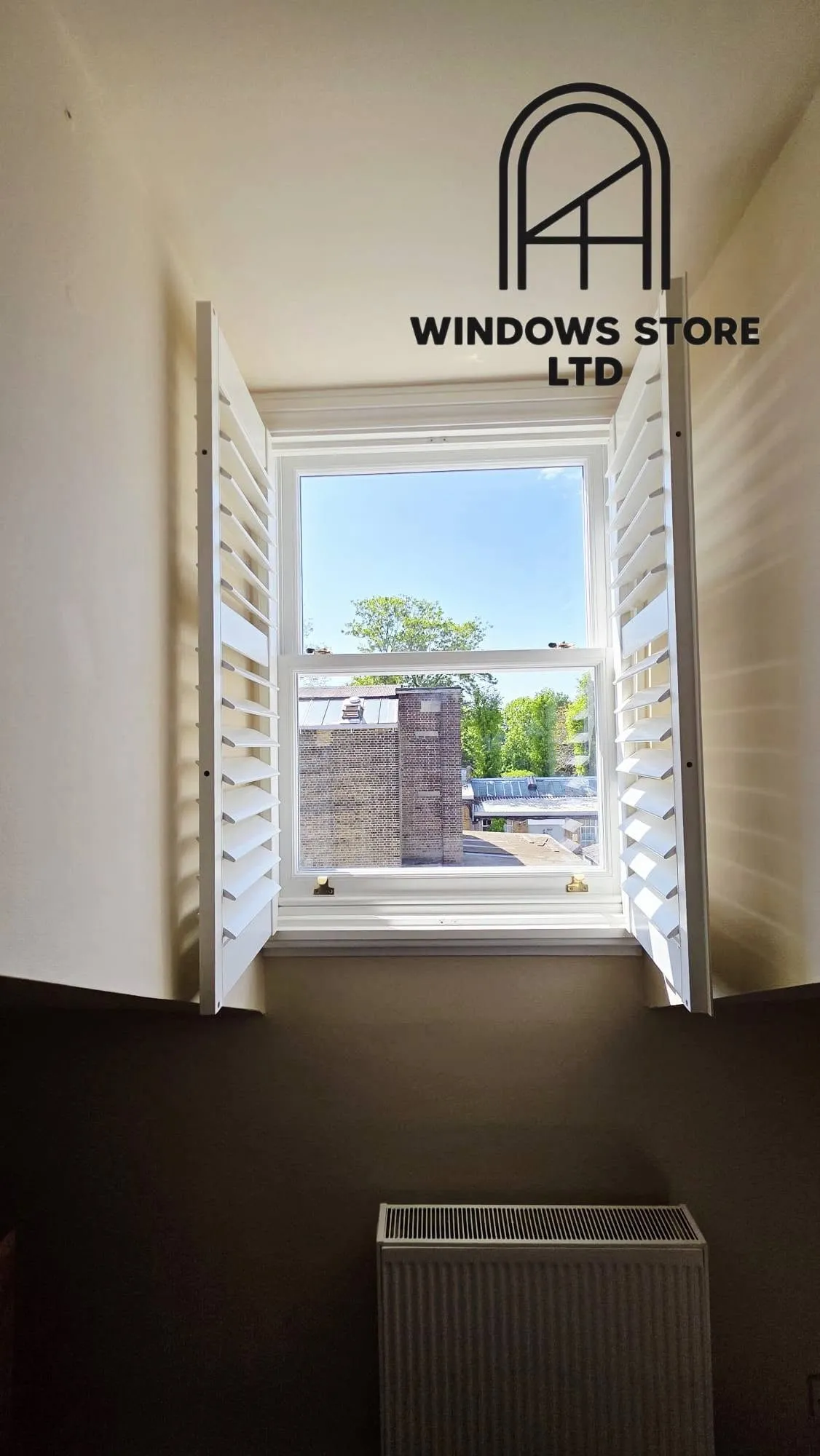 Interior shutters fitted to the reveal of a period window, London