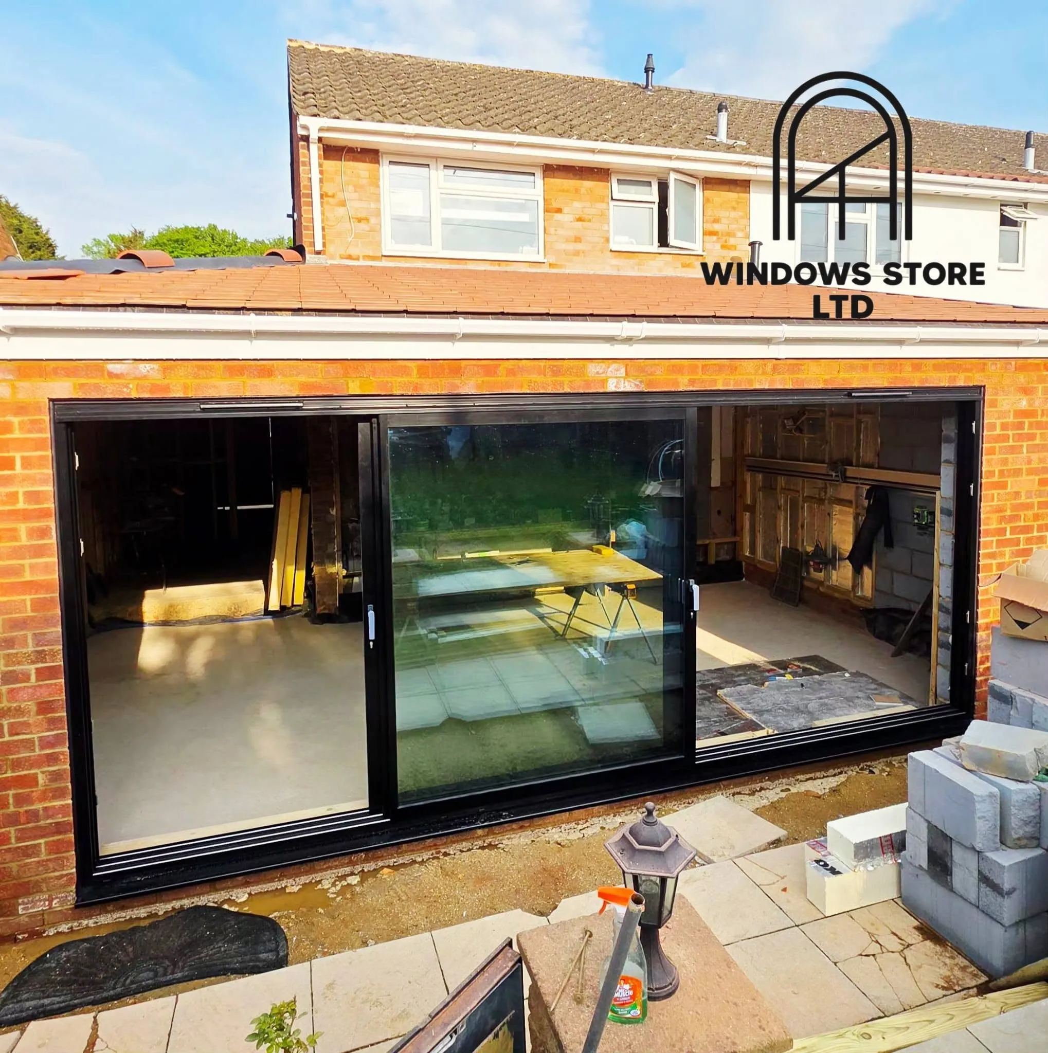 Black aluminium sliding doors across a rear wall, London