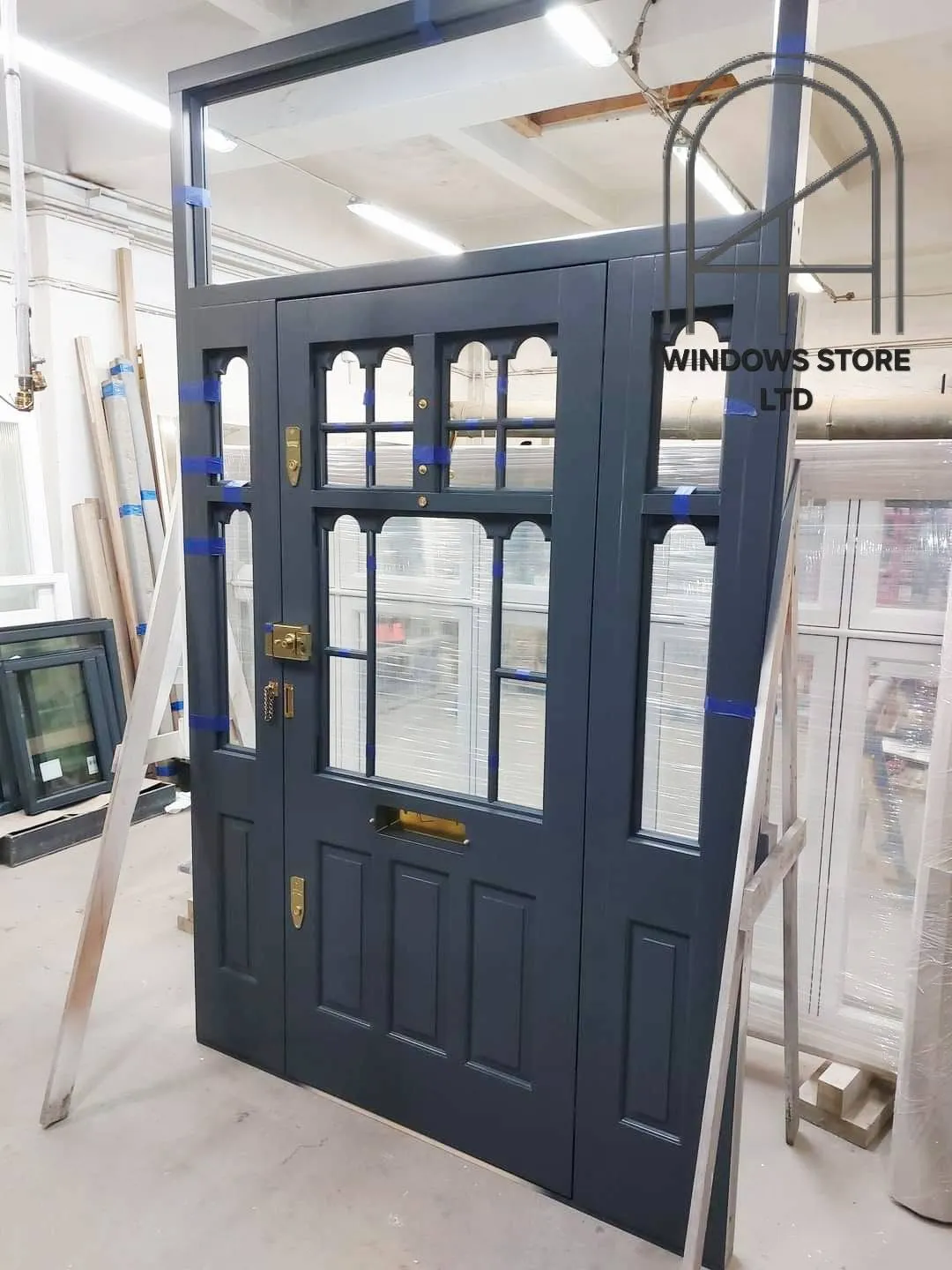 Painted timber front door with arched glazing bars and side panels