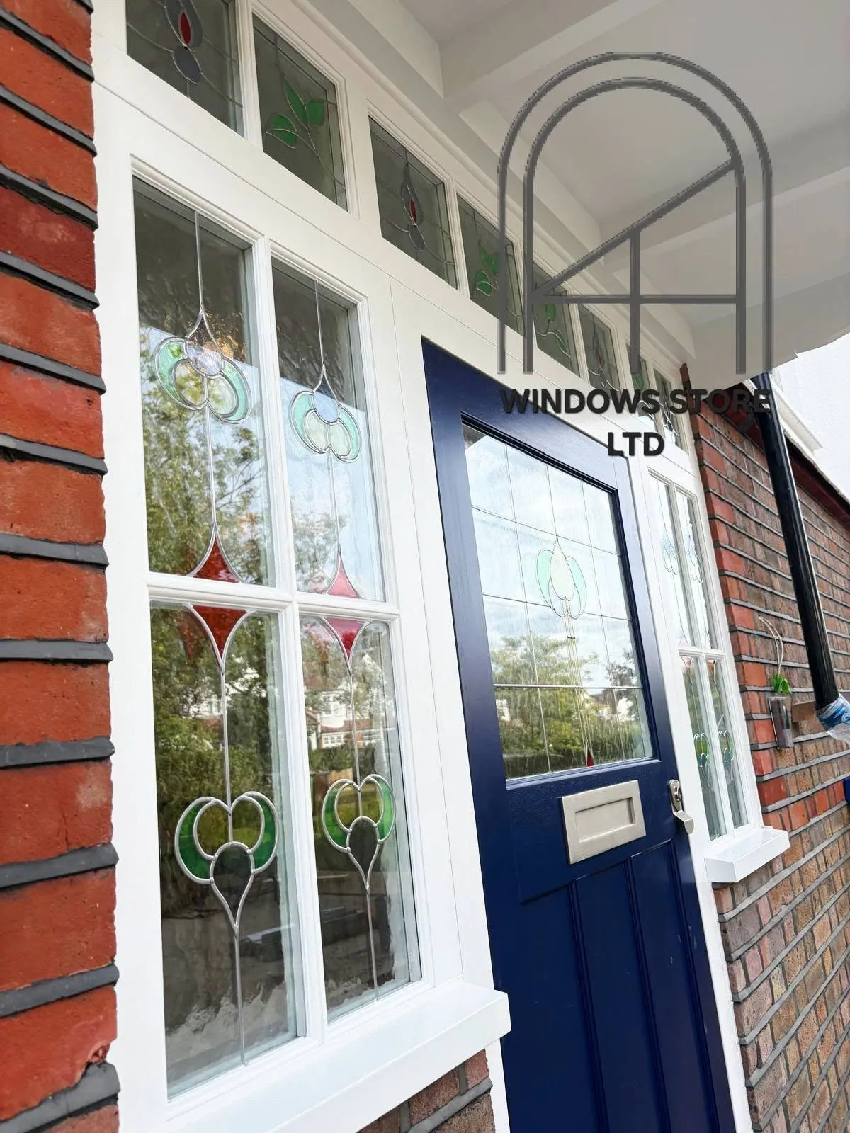 Timber front door with stained glass and matching side lights, London
