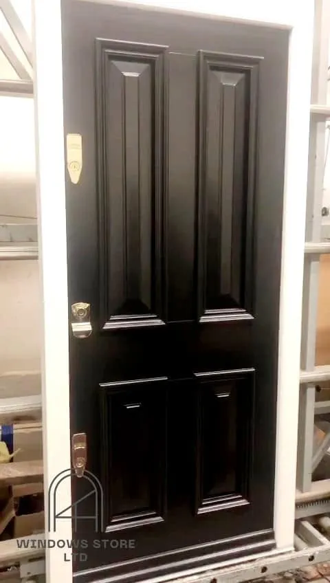 Four-panel timber front door with brass ironmongery